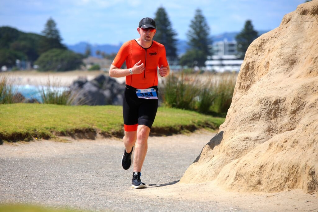 Andrew Dillon racing the run leg of the Mount Festival of Multisport Half Iron Distance Triathlon at Mount Maunganui January 2025
