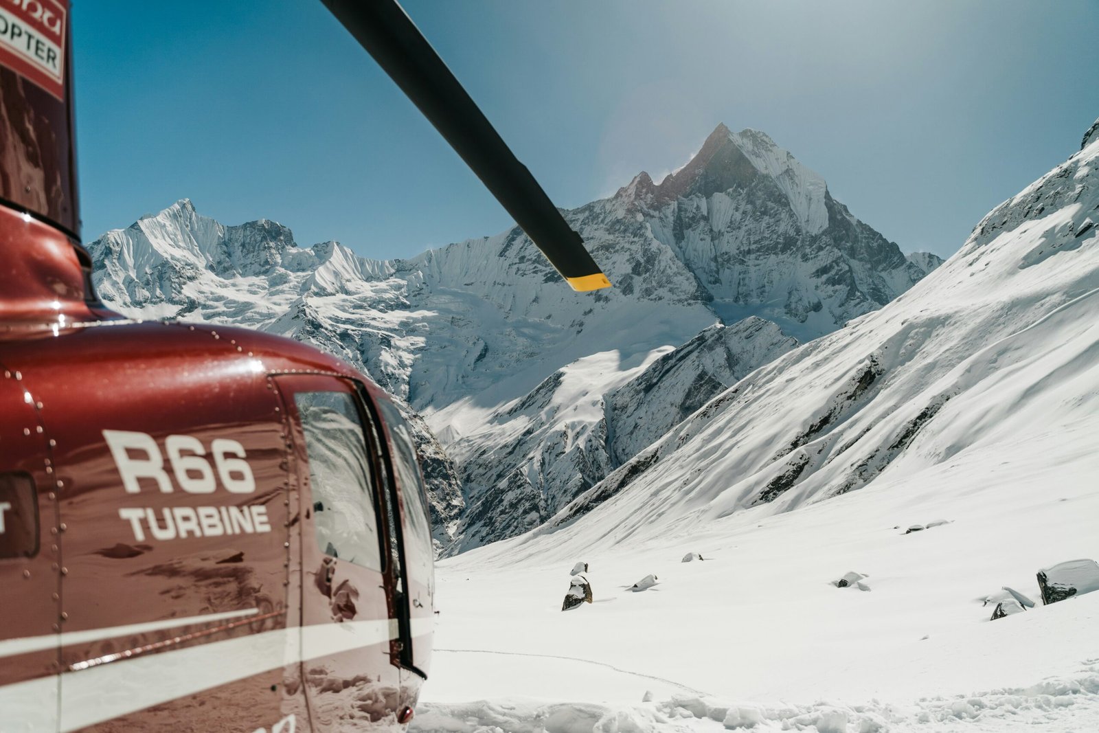 Helicopter on a mountain landing pad in Nepal — emergency helicopter evacuation is the most critical element of EBC travel insurance