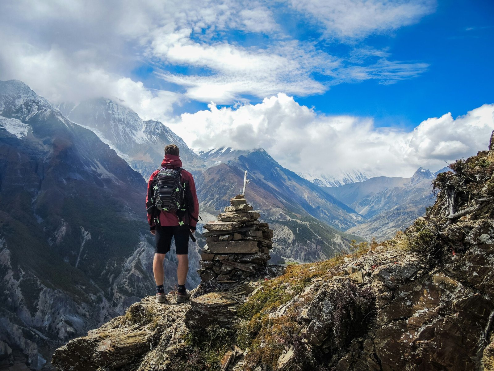 Trekker looking up at the Himalayan peaks on the Everest Base Camp trail — the mental preparation required for EBC is as important as the physical