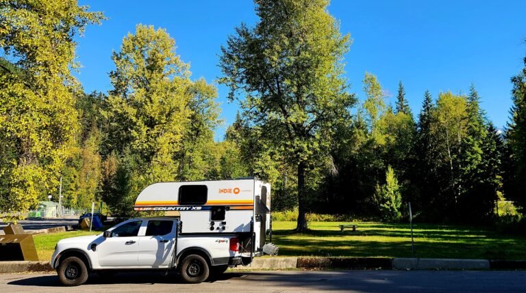 Indie Campers Ford Ranger campervan parked at Parkbridge Riverside campsite near Whistler, British Columbia